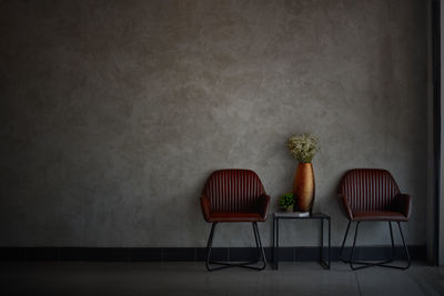 Empty chairs and tables against wall at home