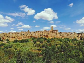 Pitigliano town on hill against blue sky