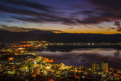 High angle view of illuminated buildings in city at night