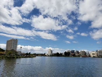 Buildings in city against cloudy sky