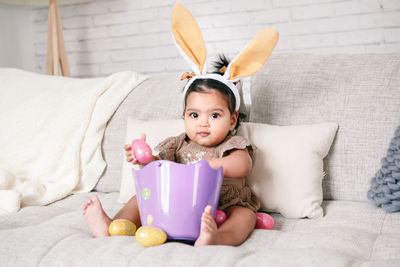 Portrait of cute baby girl sleeping on bed at home