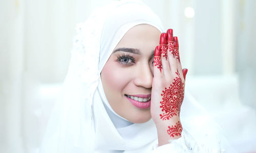 Portrait of young woman with henna tattoo