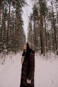 Woman standing on snow covered land