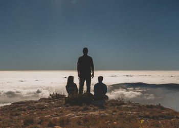 Rear view of men looking at sunset