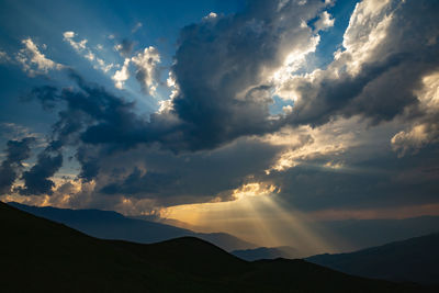 Sun rays through the clouds in the mountains