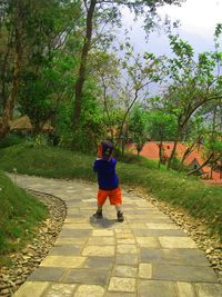 Woman walking on footpath