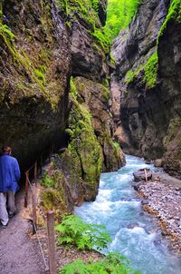 Rear view of woman looking at waterfall