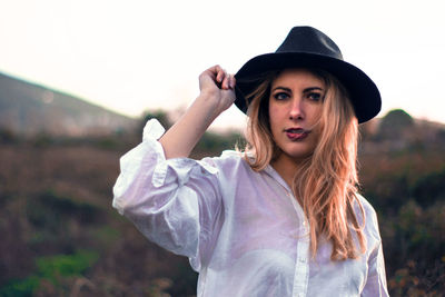 Portrait of beautiful young woman wearing hat