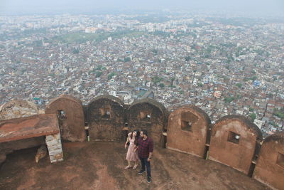 High angle view of woman and buildings in city
