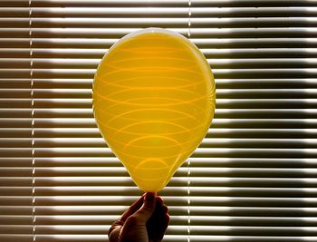 Close-up of person holding balloons