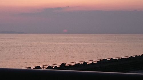 Scenic view of sea against sky at sunset