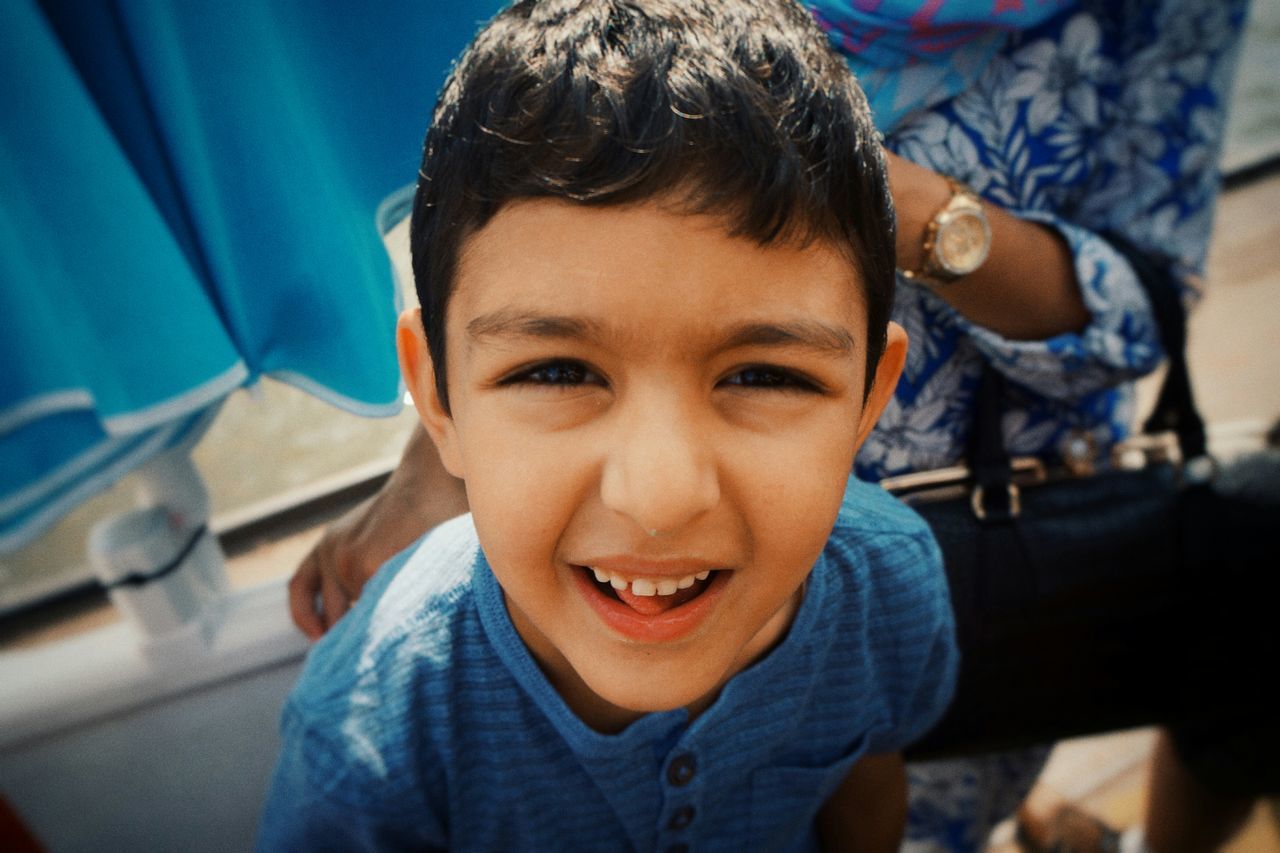 portrait, looking at camera, headshot, indoors, person, front view, lifestyles, casual clothing, focus on foreground, close-up, leisure activity, childhood, smiling, innocence, boys, young men, elementary age, cute