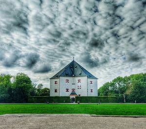 Facade of building against cloudy sky