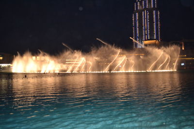 View of firework display over river at night