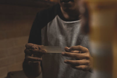 Close-up of man holding mobile phone