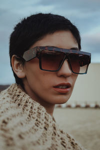 Close-up portrait of young woman wearing sunglasses