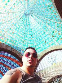 Low angle view of young man in sunglasses