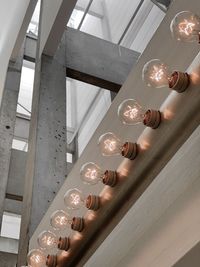 Low angle view of illuminated lights hanging on ceiling at home