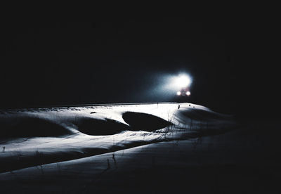 Person on illuminated car at night
