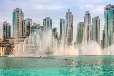 Panoramic view of sea and cityscape against sky