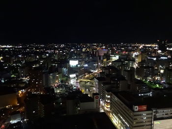 High angle view of illuminated buildings in city at night