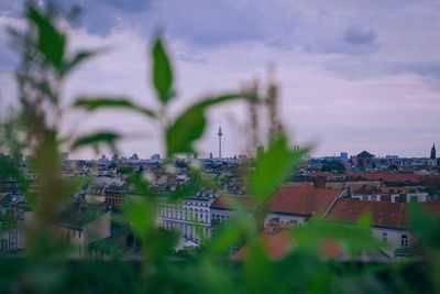 Tilt-shift image of cityscape against sky