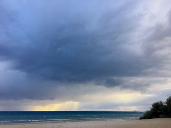 Scenic view of sea against storm clouds