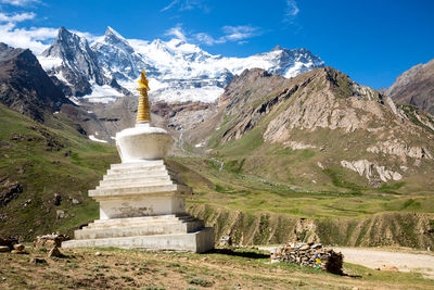 Statue of church against cloudy sky