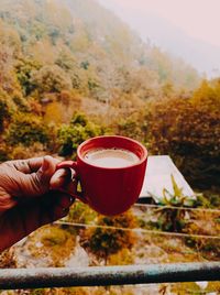 Cropped hand holding coffee