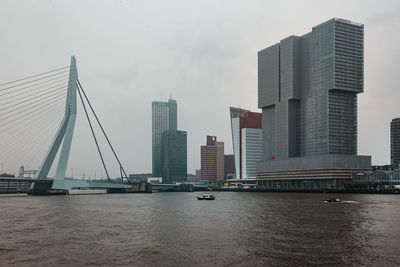 View of bridge over river with buildings in background