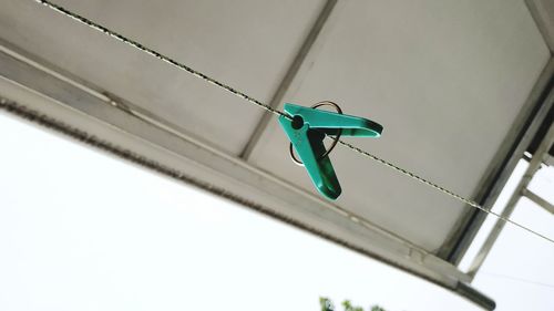 Low angle view of clothespin on clothesline