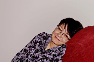 Portrait of smiling senior woman relaxing at home