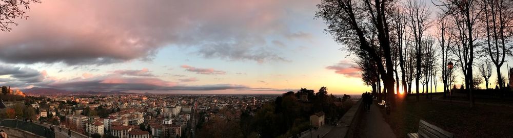 Panoramic shot of townscape against sky at sunset