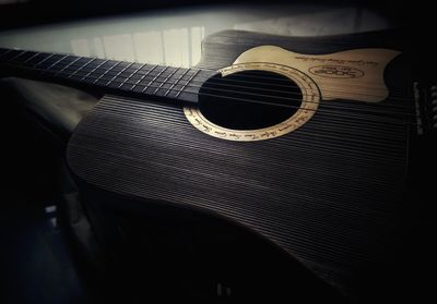 Close-up of guitar on table