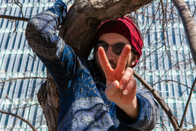 Portrait of woman with hat on tree