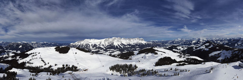 Scenic view of snow covered mountains against sky