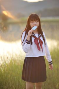 Young woman standing on field