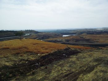 Scenic view of landscape against cloudy sky