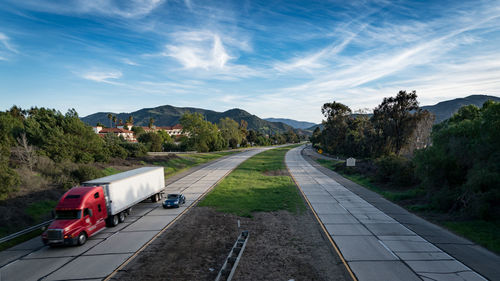 Vehicles on road against sky