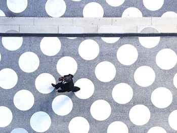 Directly above shot of businessman walking on patterned footpath