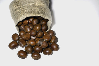 High angle view of coffee beans against white background