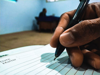 Close-up of hand holding paper