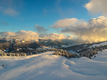 Scenic view of snow covered landscape against sky