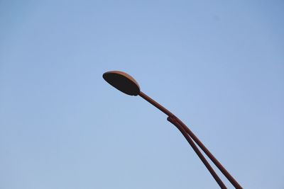 Low angle view of power lines against clear blue sky