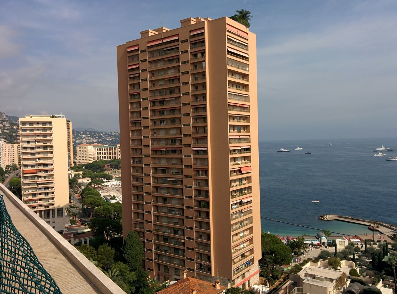 building exterior, architecture, built structure, sea, sky, water, city, horizon over water, beach, cloud - sky, modern, building, day, outdoors, tower, office building, shore, tall - high, no people, skyscraper