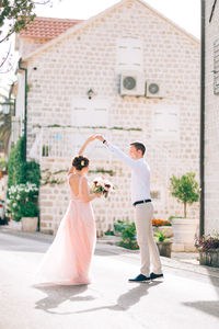 Full length of couple standing in city