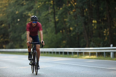 Man riding bicycle on road