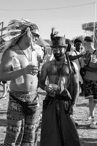 People in traditional clothing against clear sky