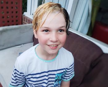 Smiling boy sitting outdoors