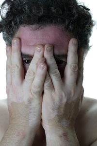 Close-up portrait of woman covering face